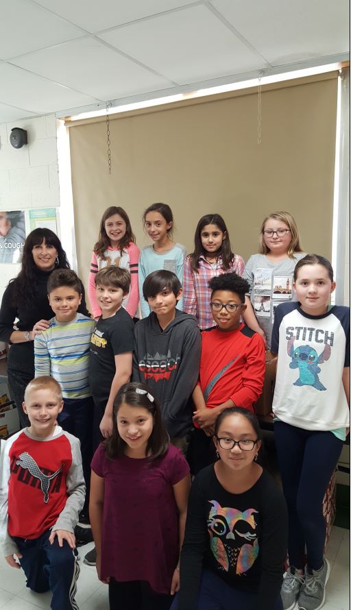 Photo here is Kelly Caci, school psychologist, pictured with New Windsor School Clintonian Society students, who helped by collecting donated food from classrooms each day.
