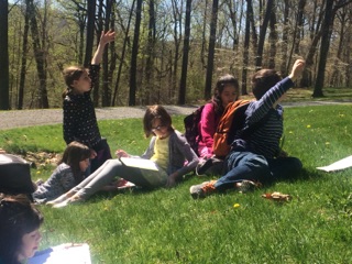 Even more students working on the grass outside.