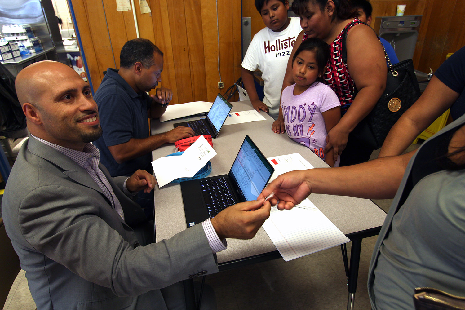 Superintendent Dr. Padilla helps people check in to the event.