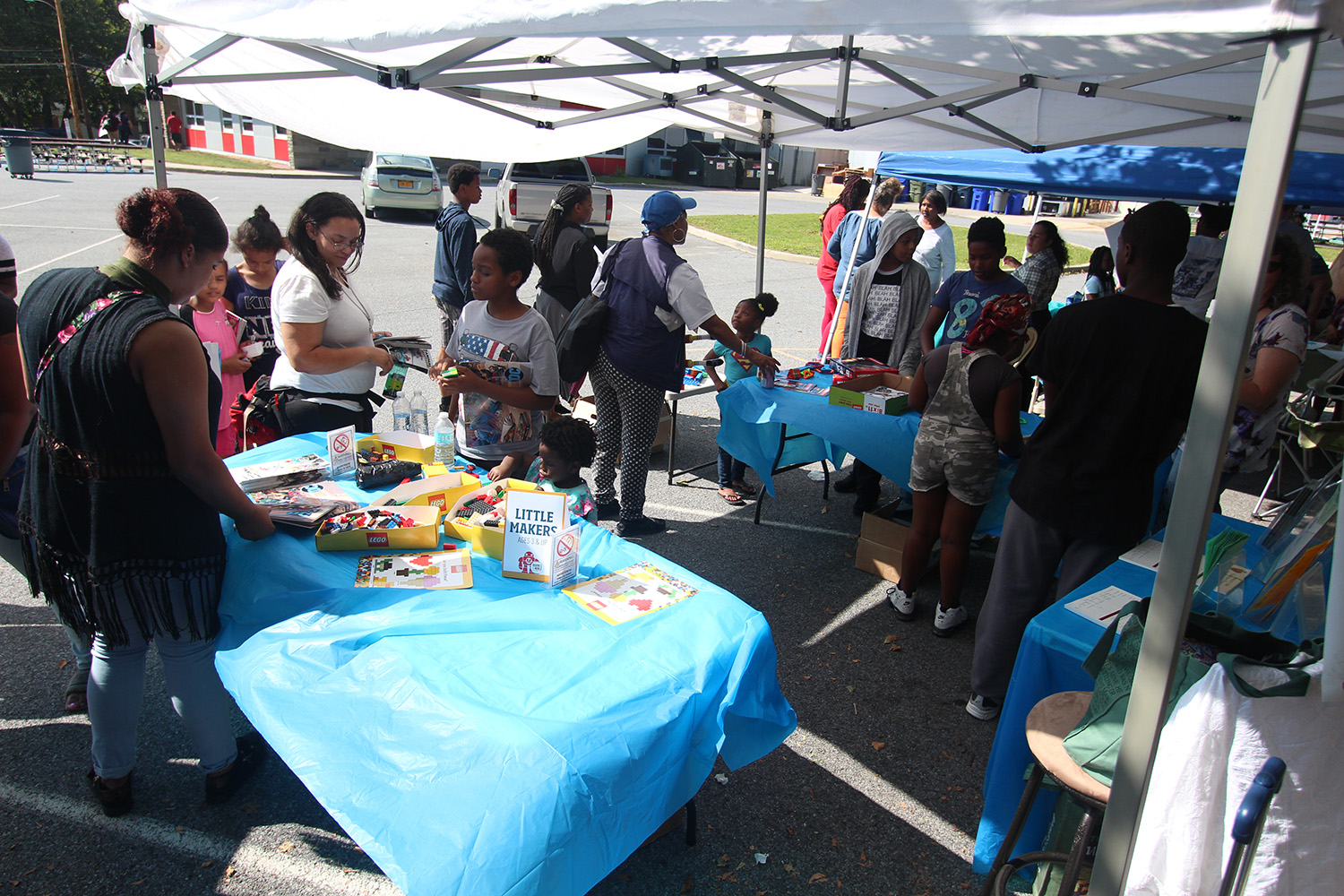 Attendees visit a booth for one of the community partners