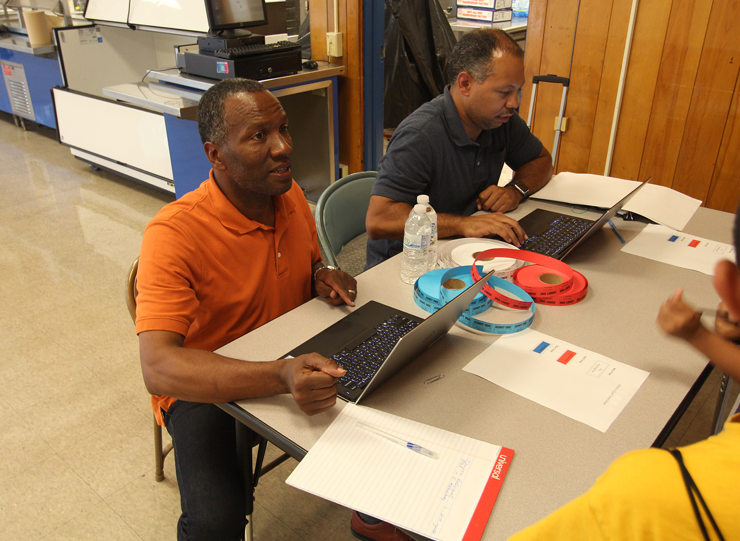 Anthony Grice helps check in attendees.