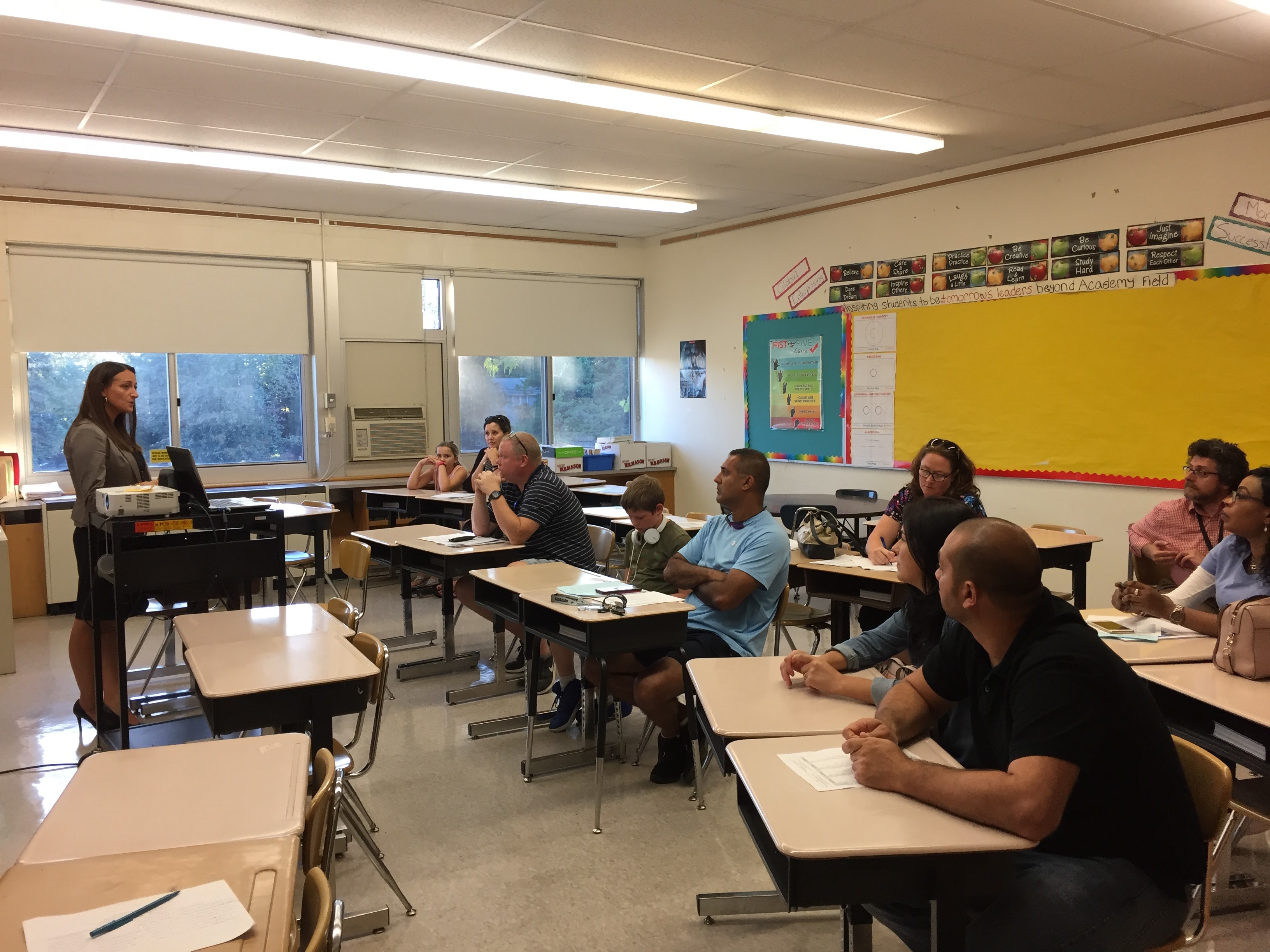 Teacher talking to families at Open House