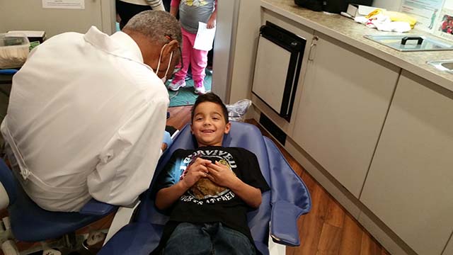 The dentist discusses dental hygiene with students