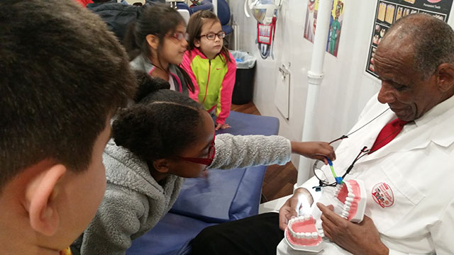 The dentist shows how teeth work to students