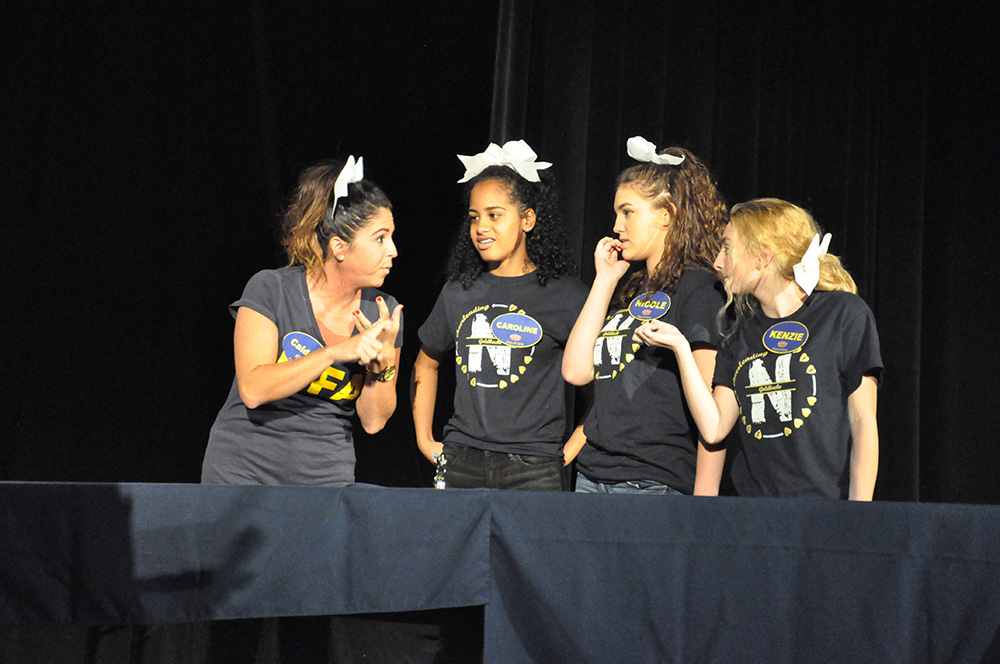 The cheerleaders team contemplates their answer