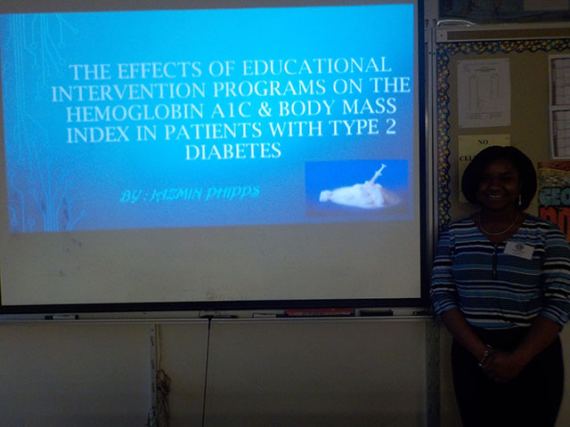 Jazmin Phipps standing in front of her presentation