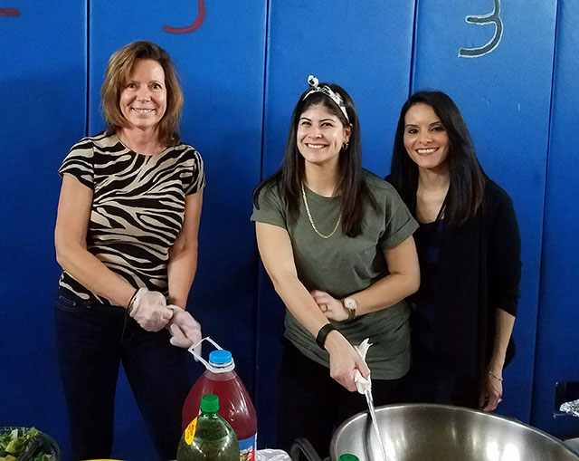 Teachers serving food at the celebration