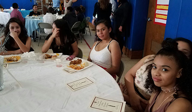 A group of students at their table.