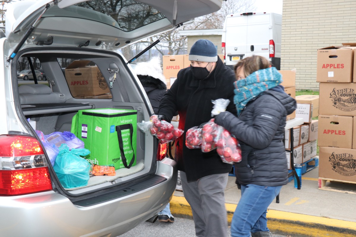 Principal Mr. Scott Prokosch distributes food with volunteer.