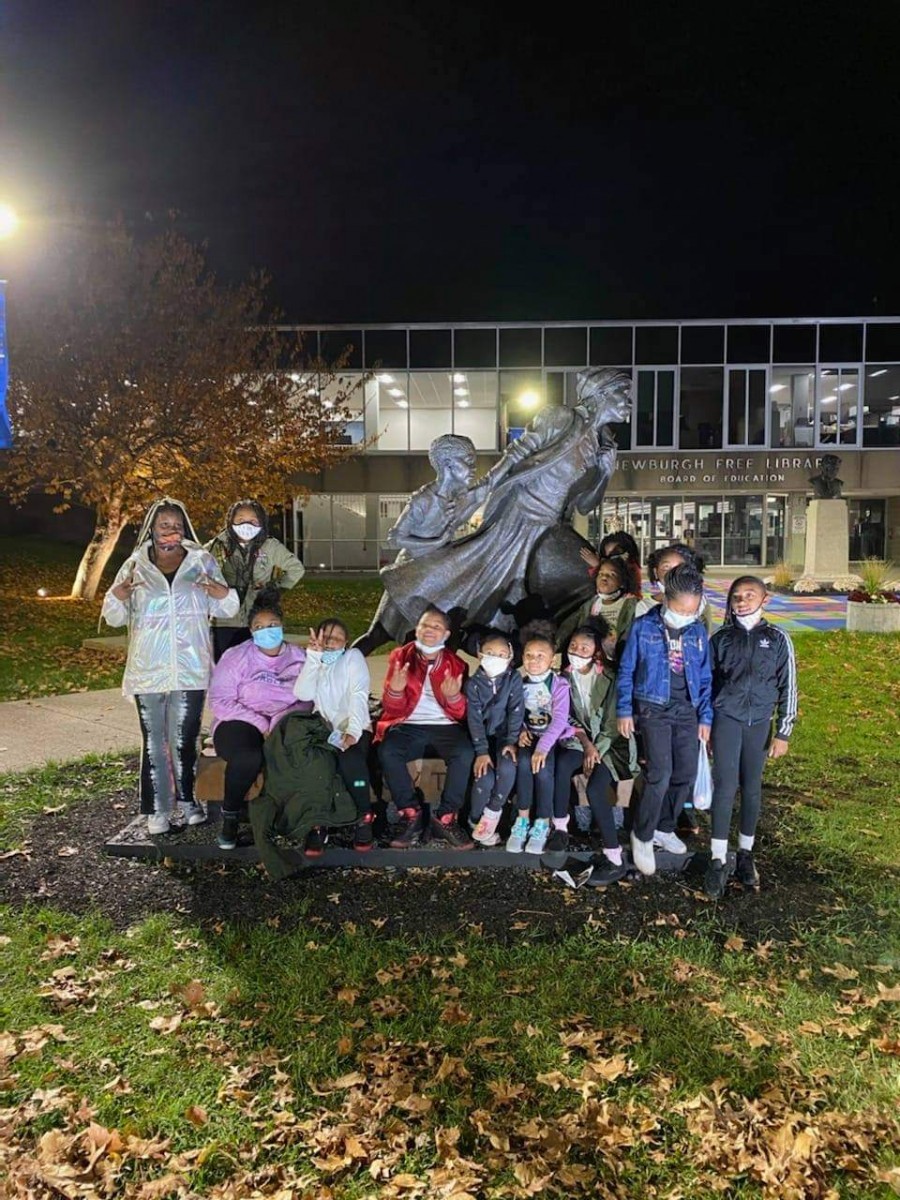 Photo of children around the visiting Harriet Tubman statue.