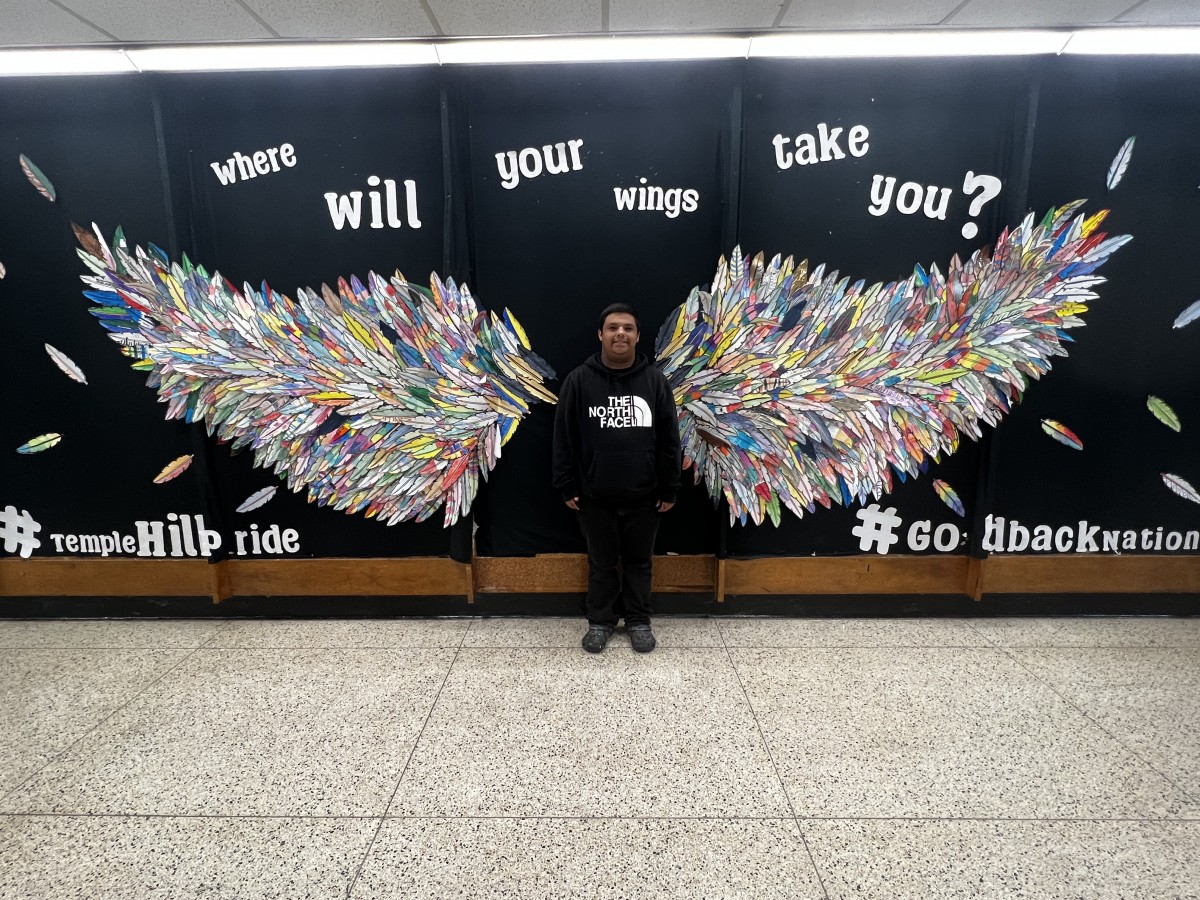 1 student with Wings Mural