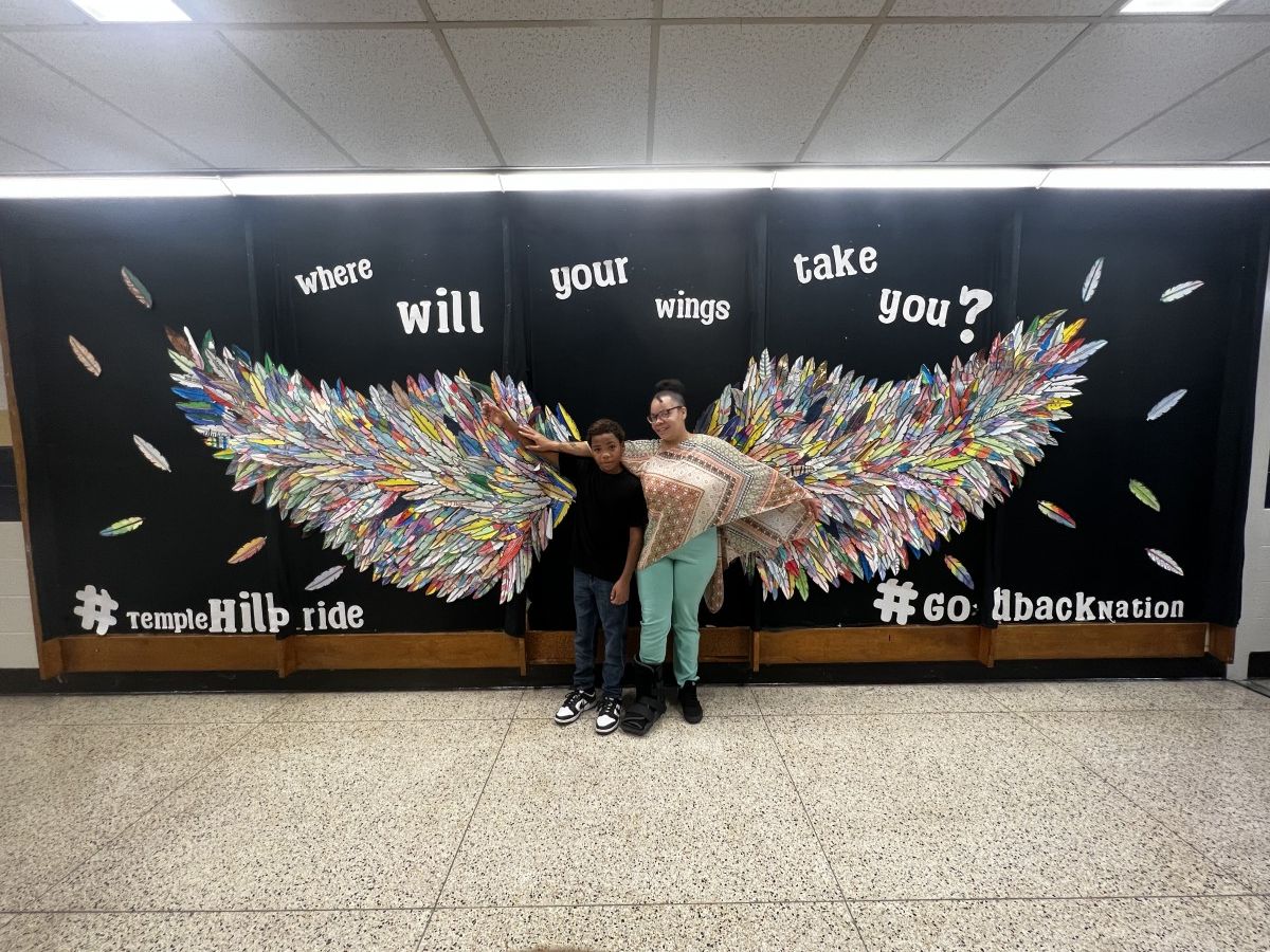Student and adult with Wings Mural