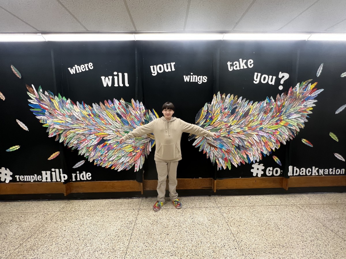 Student and adult with Wings Mural