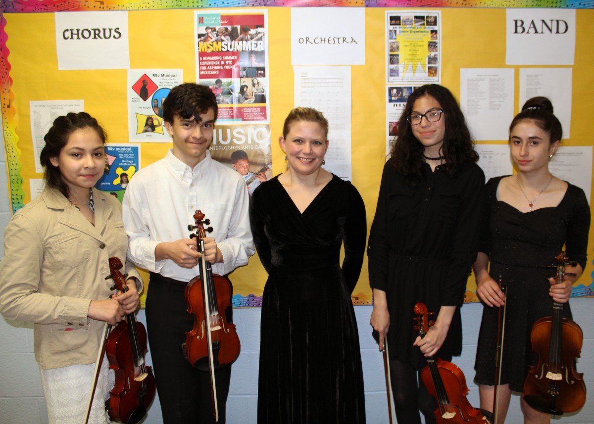 The Eighth Grade Select Orchestra Group. (From L to R) Emily Palacios, David Peterson, Ms. Allen, Isabella Delgado and Sarah Murphy.