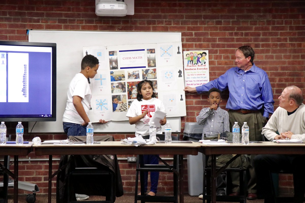 4th grade Isabella explains the game of chess to Armory Board members