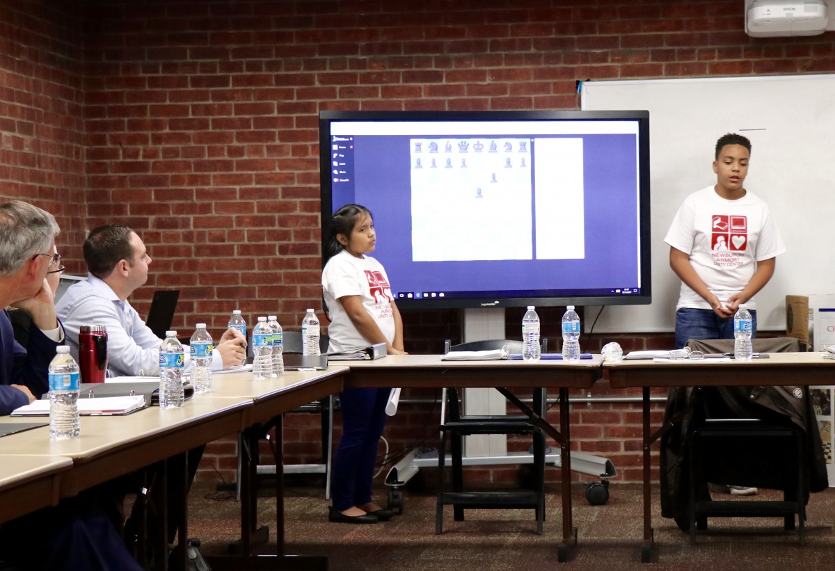 4th grade Isabella explains the game of chess to Armory Board members