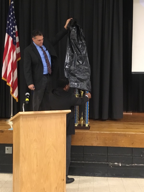 Mr. Ventura Lopez, principal of Temple Hill Academy unveils the trophy