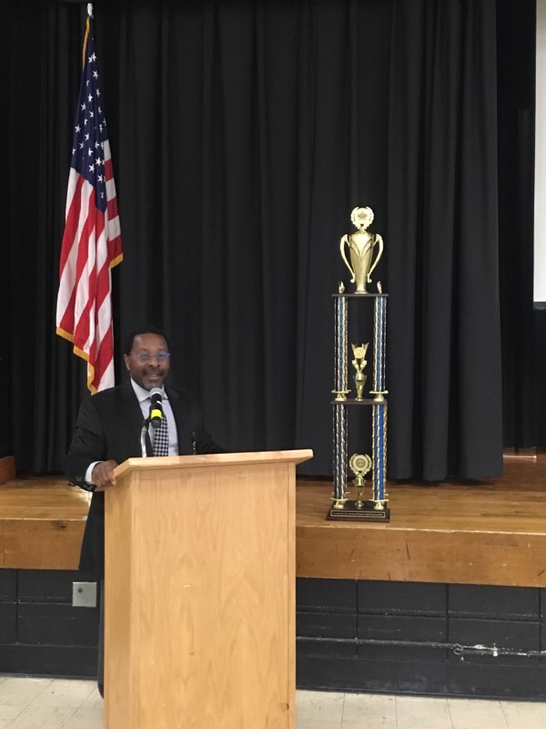 Assistant Superintendent for Human Resources, Mr. Michael McLymore presents the trophy