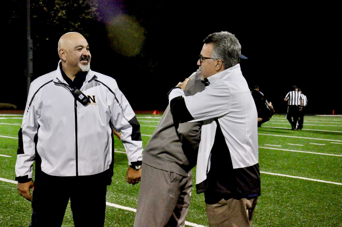 Coach Malcolm Burks honored as Boy’s Track and Field Coach of the Year at a football game. Pictured with Principals Rodriguez and Doddo.