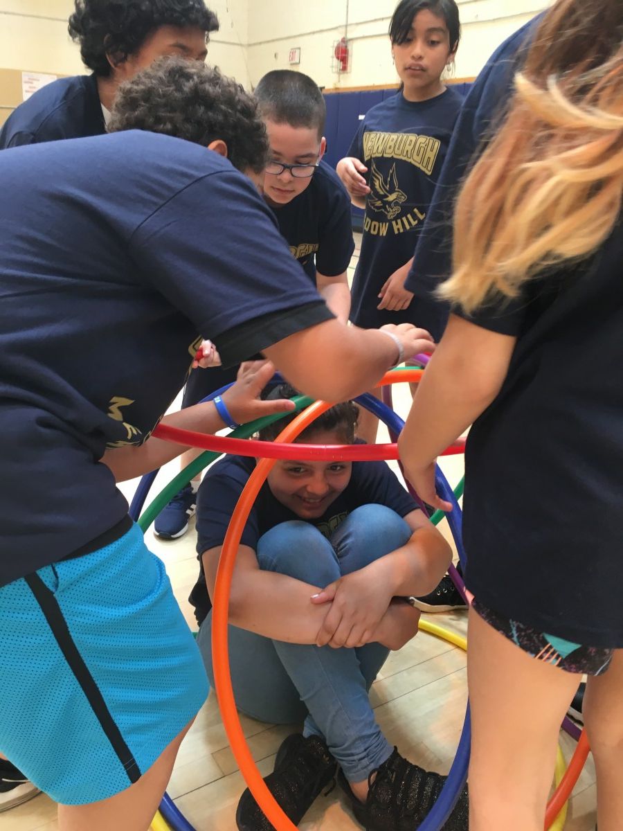 Students participate in activity with hoops.