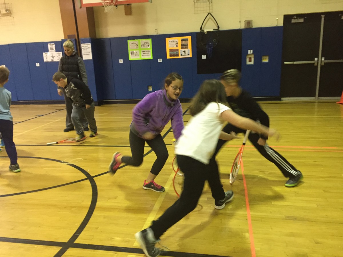 Students practice tennis skills as part of the program.