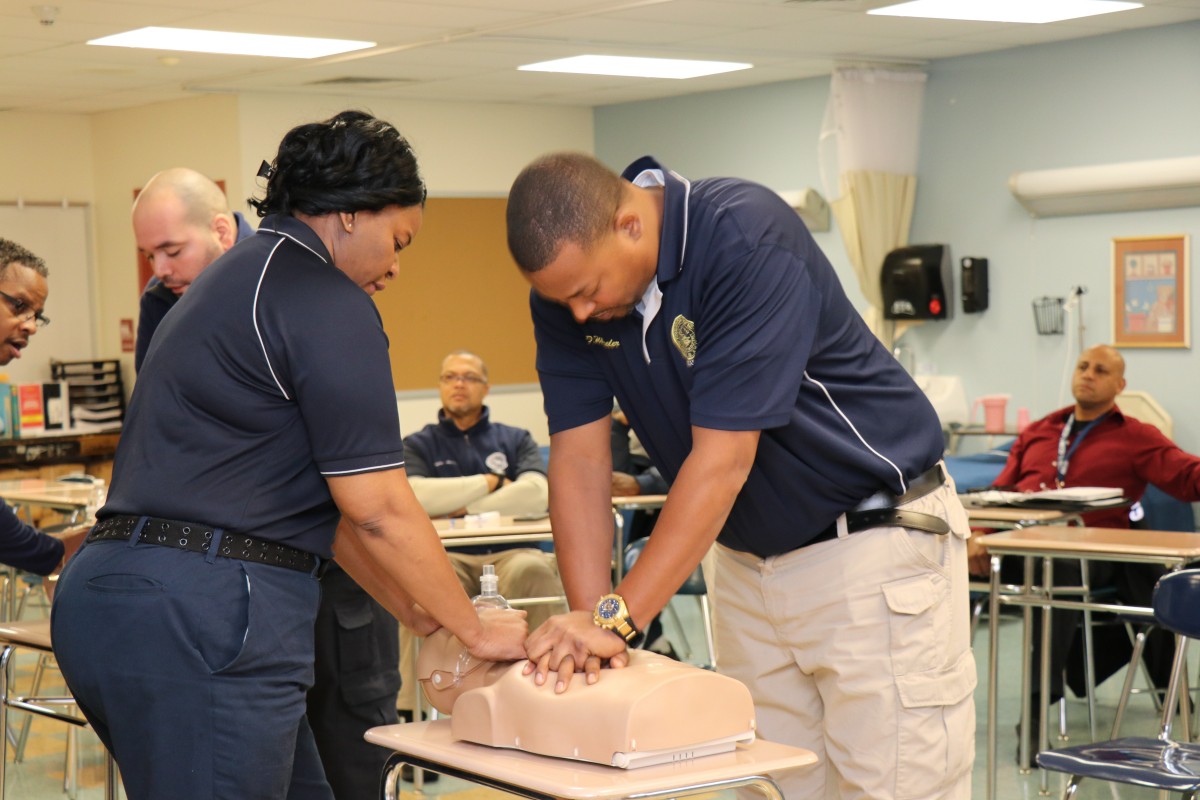 Security guards practicing proper form for basic life Basic Life Support (BLS) CPR.