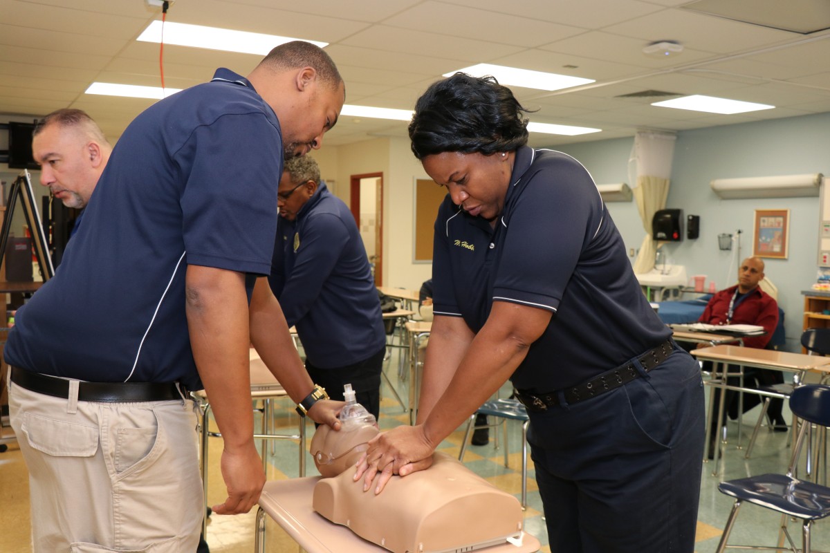 Security guards practicing proper form for basic life Basic Life Support (BLS) CPR.