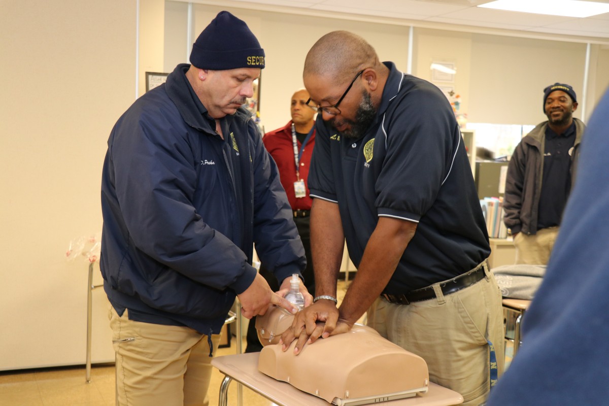 Security guards practicing proper form for basic life Basic Life Support (BLS) CPR.