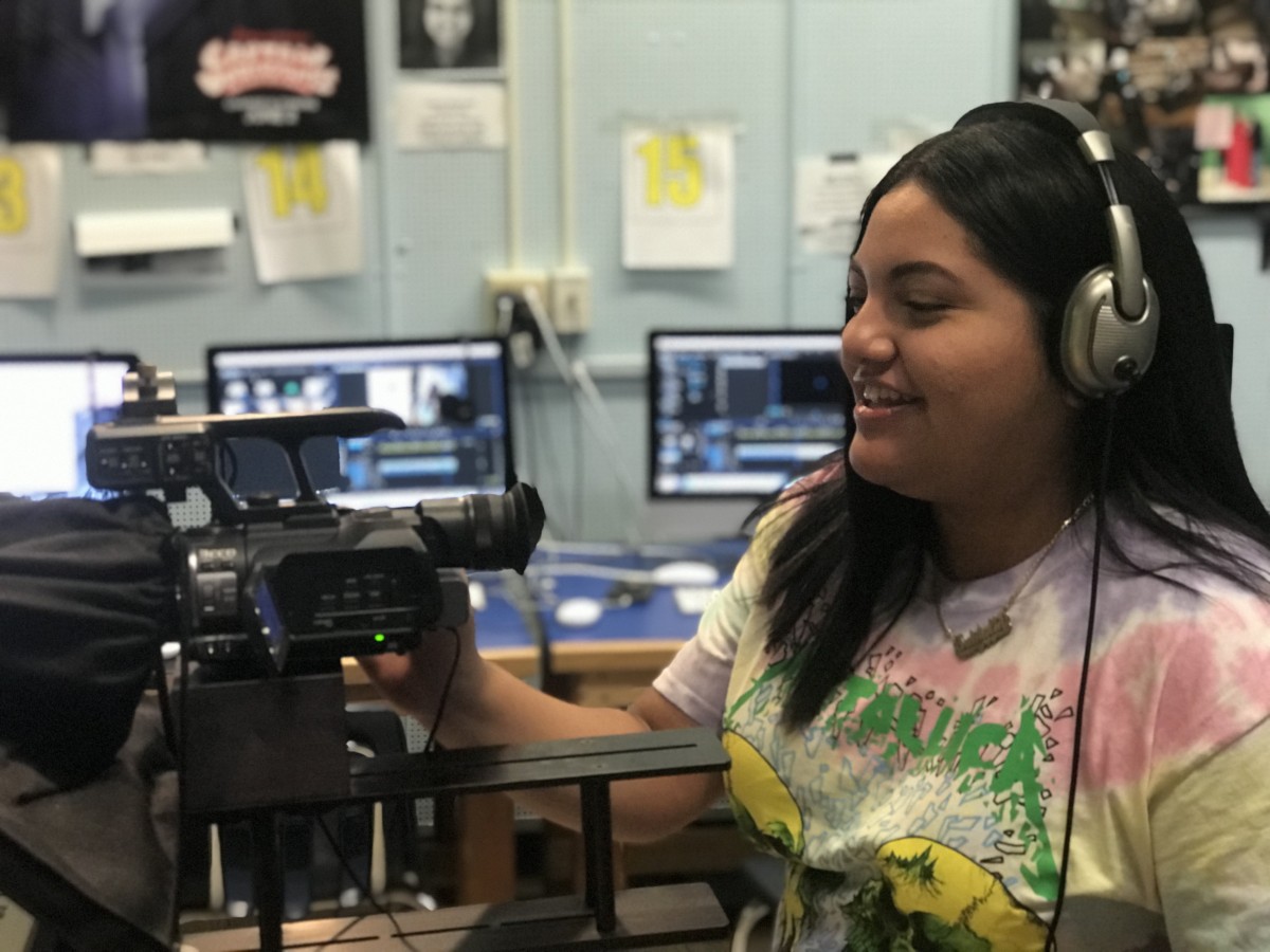 Studio using a camera and headset to film in the studio.