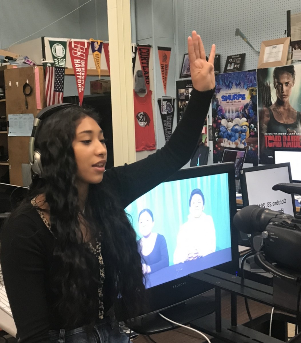 Student directing the filming of morning announcements.