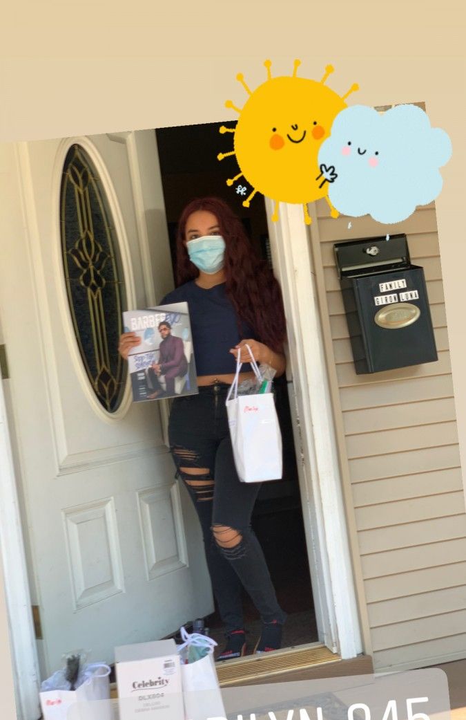 Student poses with a picture holding their supplies.