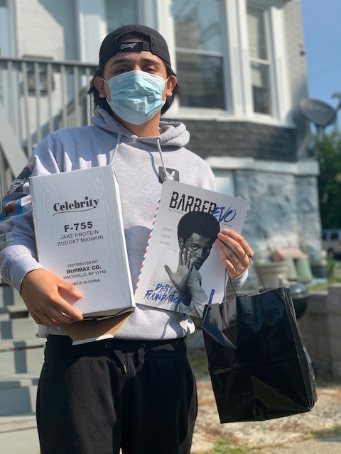 Student poses with a picture holding their supplies.