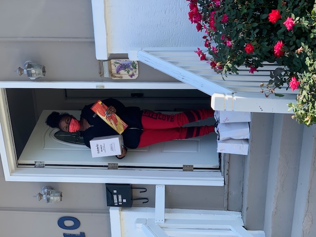 Student poses with a picture holding their supplies.