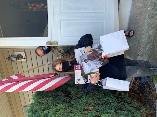 Student poses with a picture holding their supplies.