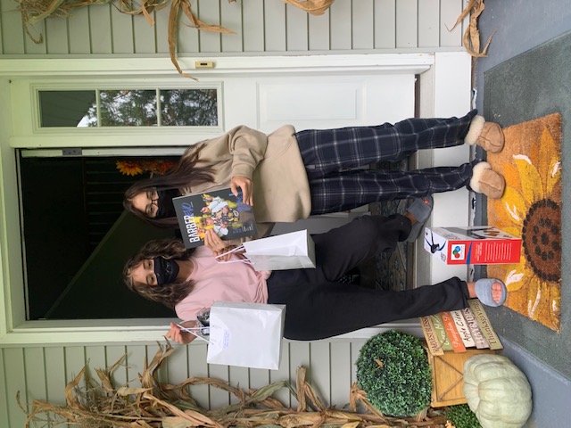 Students pose with a picture holding their supplies.