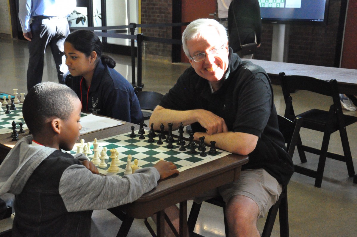 Board member, Mr. Johnston plays chess at Newburgh Armory