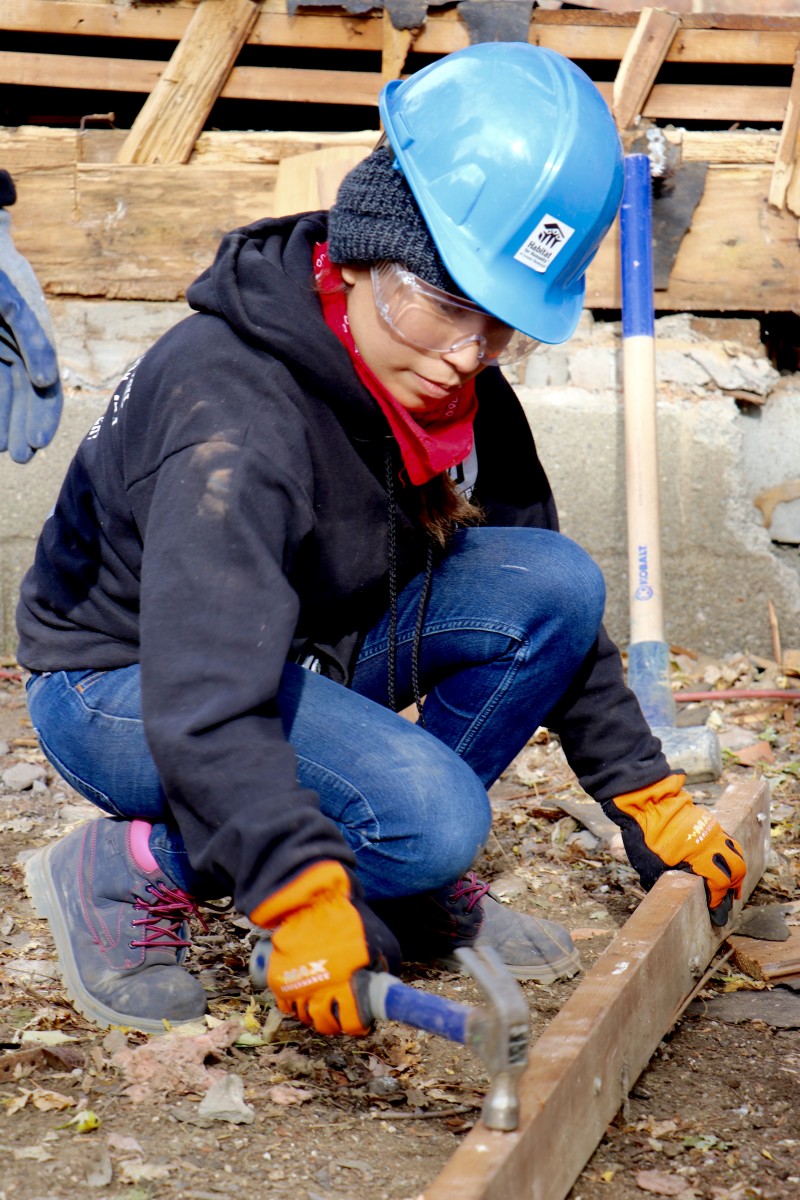 Student hammers nail