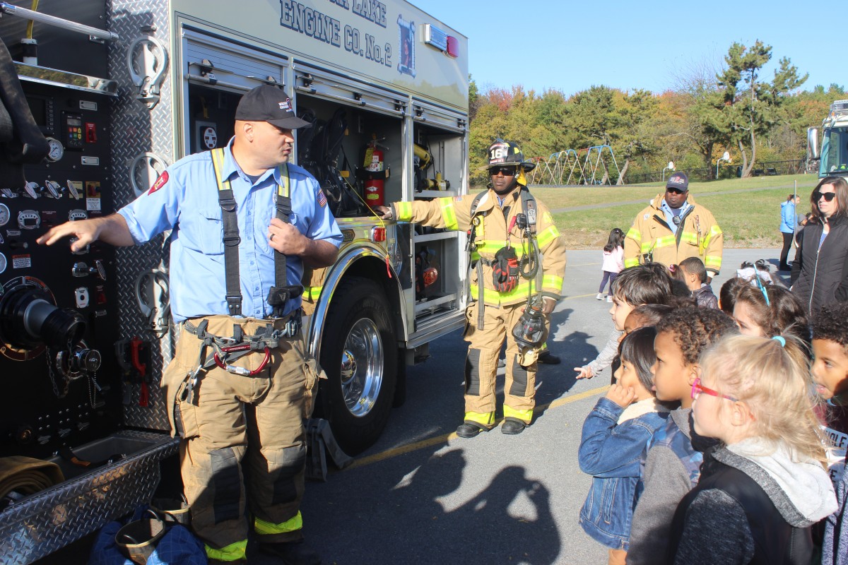 Students learn from a firefighter.