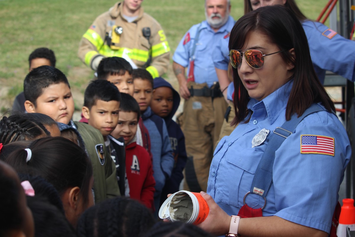 Students learn from a firefighter.