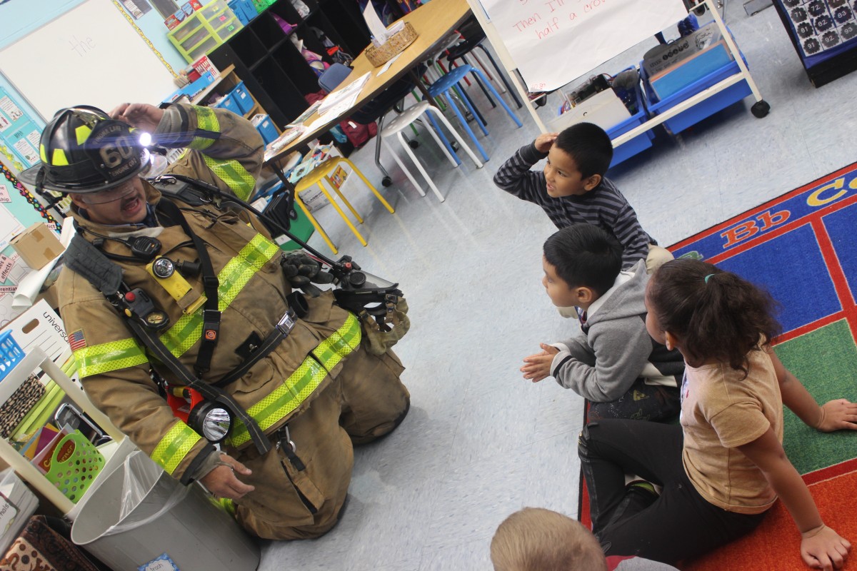 Students learn from a firefighter.