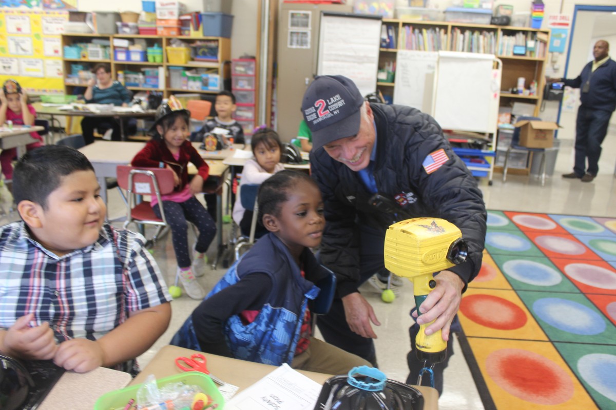 Students learn from a firefighter.