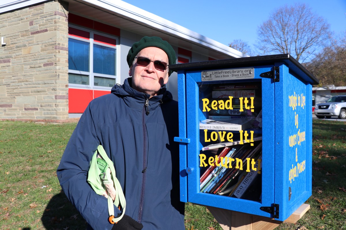 Mr. Powers poses for a photo by the donated box.