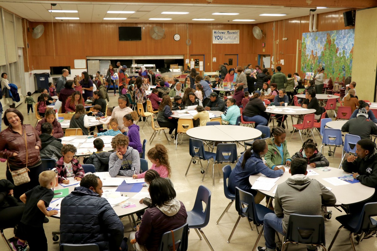 Crowd in gym participating in event