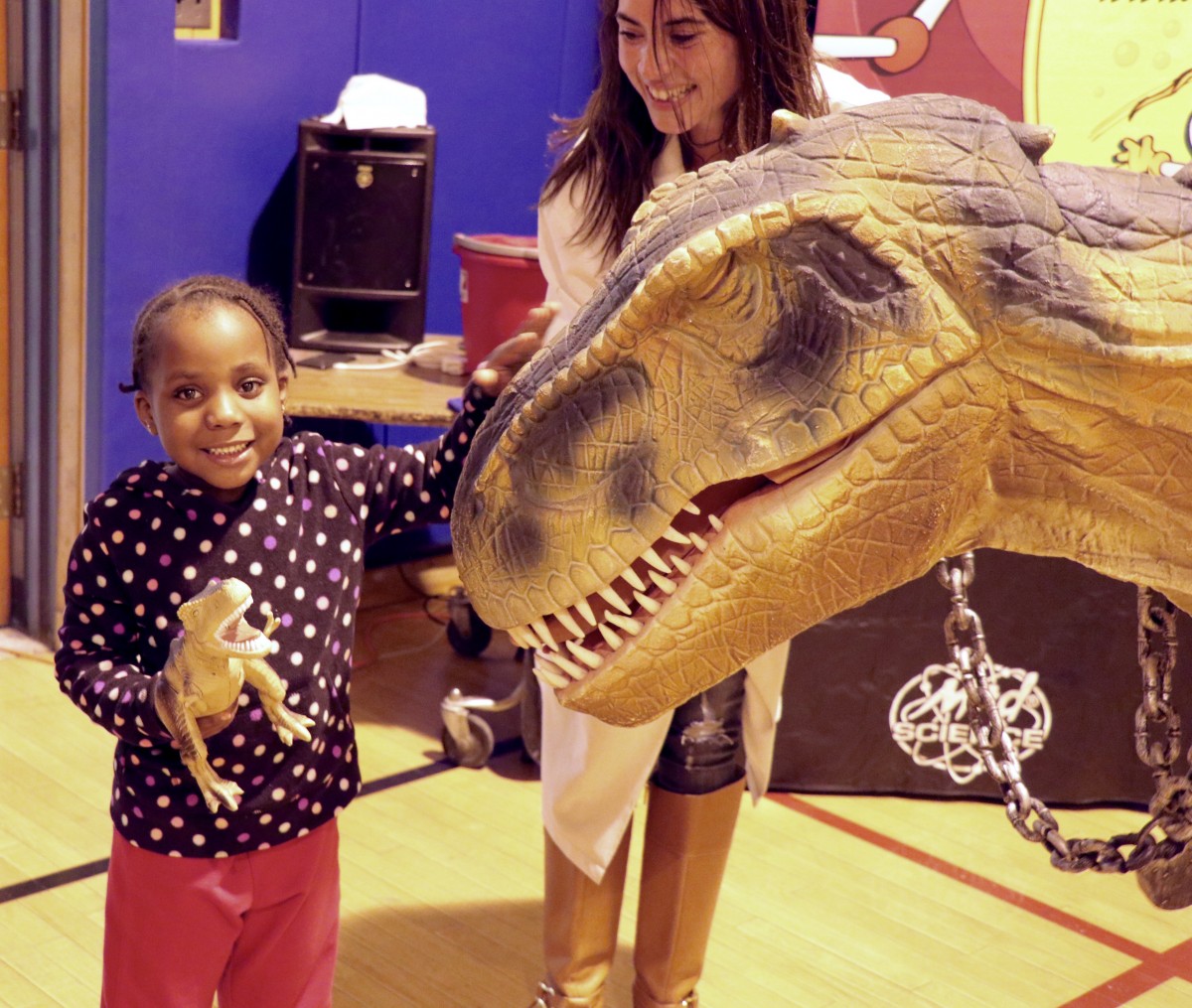 Student poses with Fluffy the T-Rex