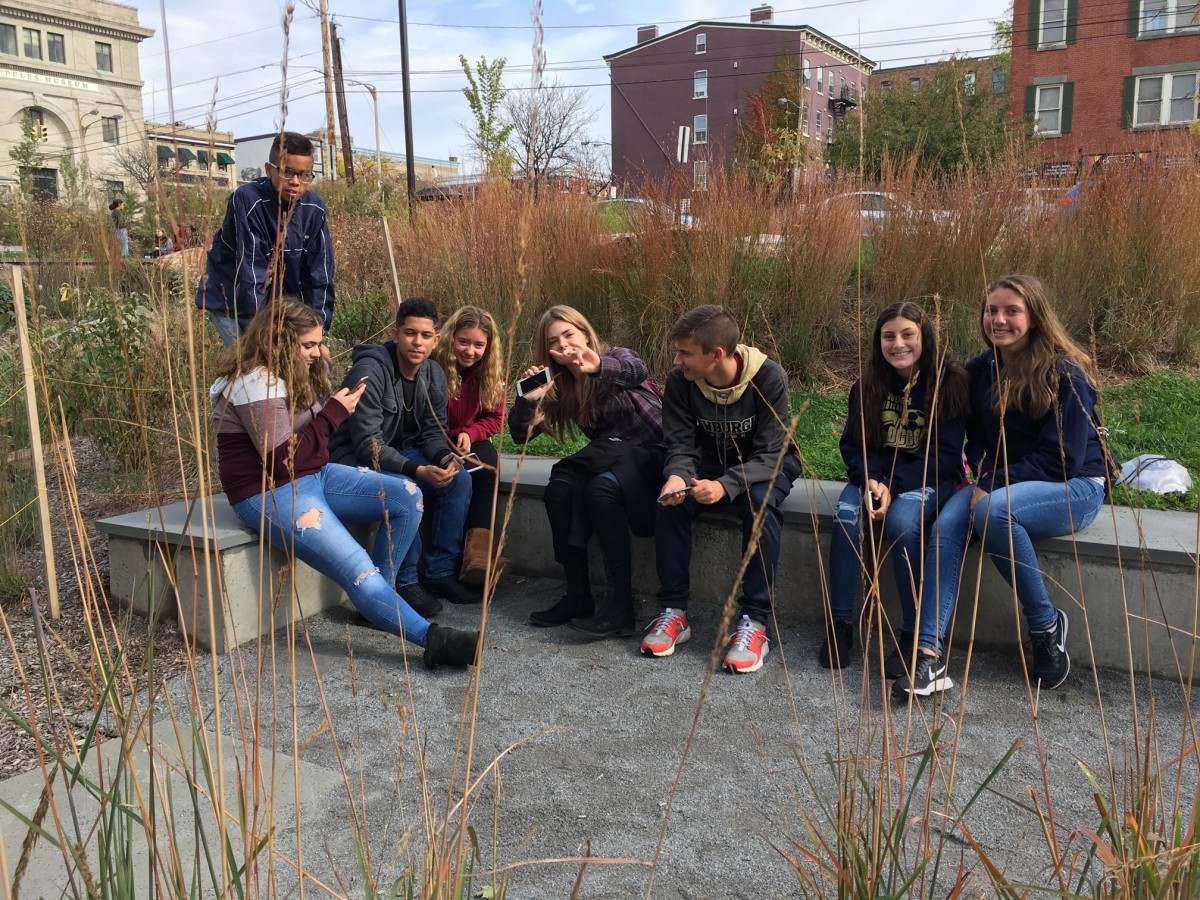 Freshmen relaxing in the park on the corner of Liberty St. and Broadway