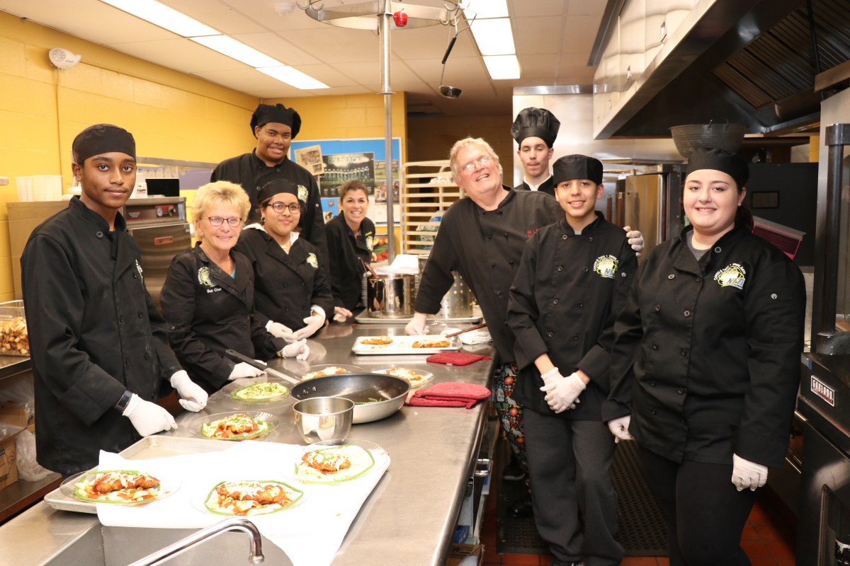 NFA Culinary students pose for a photo with teachers and administrators.