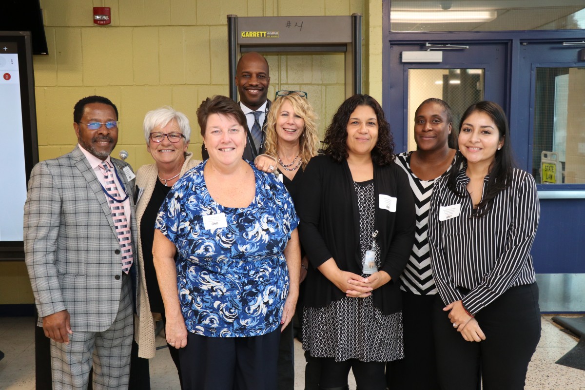 NFA Culinary students pose for a photo with teachers and administrators.