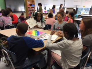 Students in Ms. Hoffman's class share their math games with students from Mrs. St. Clair's class.