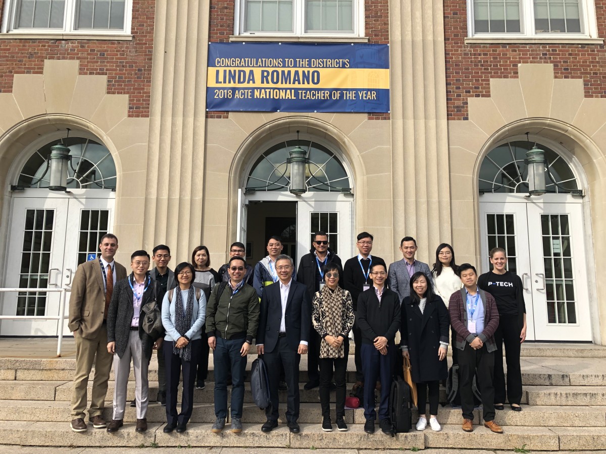 Group from Hong Kong poses in front of the high school.