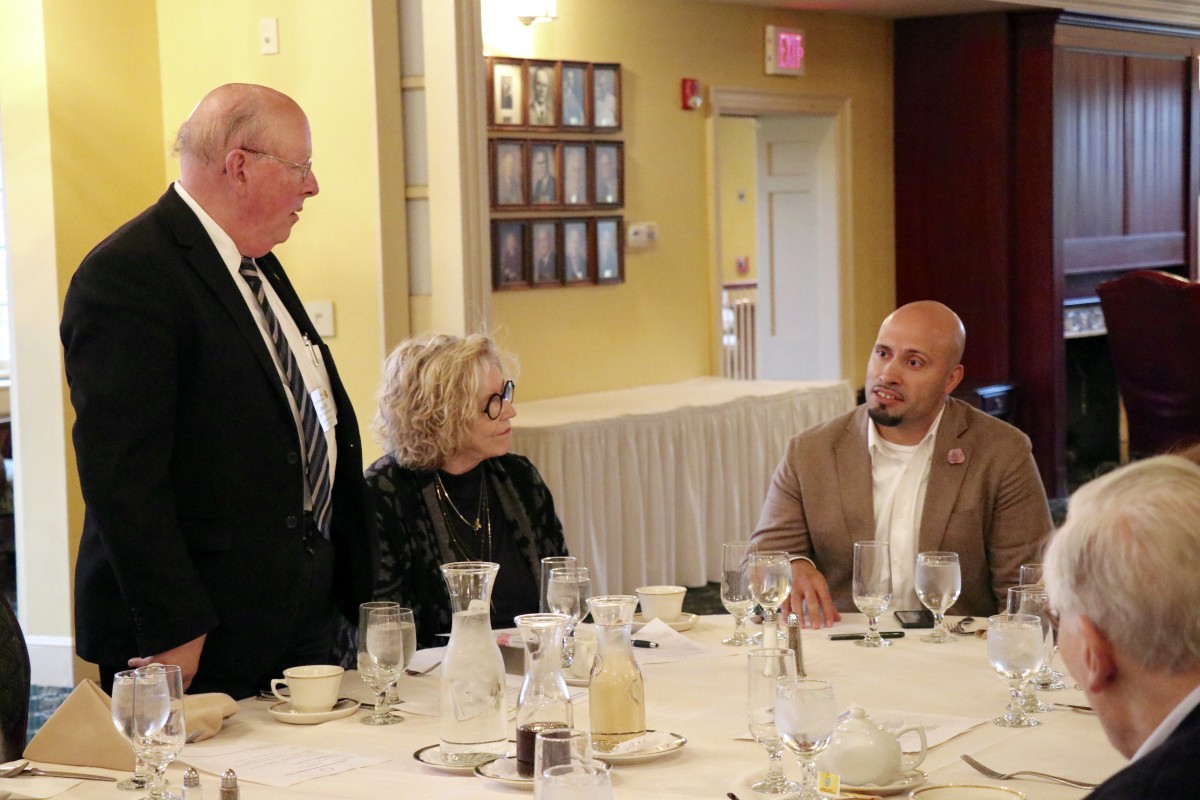 Dr. Padilla stands with members of the Rotary Club during initiation